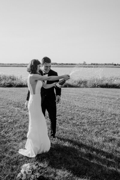 Tuscan inspired Renault winery wedding in Egg Harbor New Jersey.  Bride and Groom smile at each other in front of their floral wedding arch that they got married under.