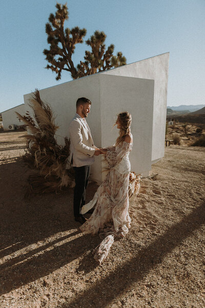 A boho wedding couple exchanging vows at Le Chacuel