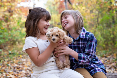 Brother and sister holding dog in Minneapolis for family photography