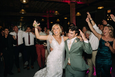 bride and groom with drink in hand at their wedding reception by wedding videographer and wedding photographer tampa bay