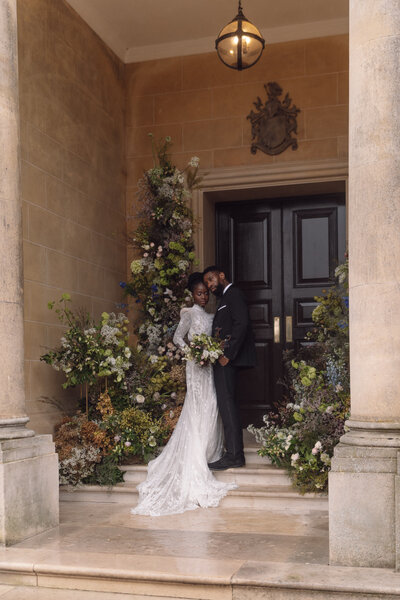 Groom smiles and takes a picture with a film camera of his wife at a central London wedding ceremony