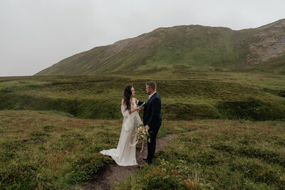 A couple reads their vows during their elopement ceremony in Alaska.