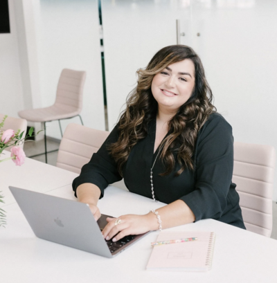 showit designer makena smiling at her laptop