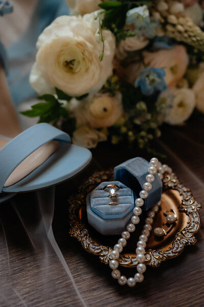 wedding details including the wedding rings, bridal bouquet, shoes, and various bridal jewelry