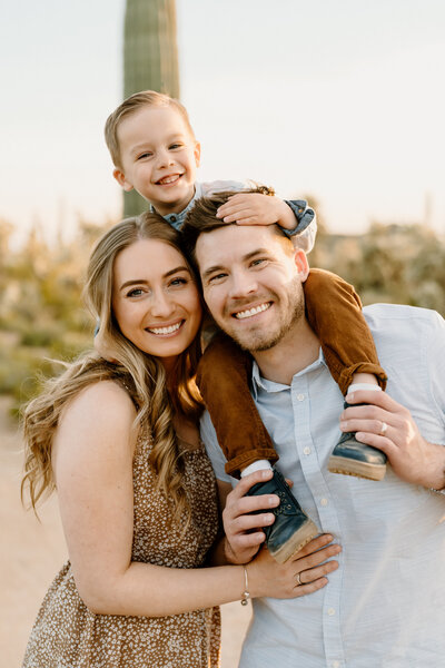 parents pose with son on dad's shoulders in arizona