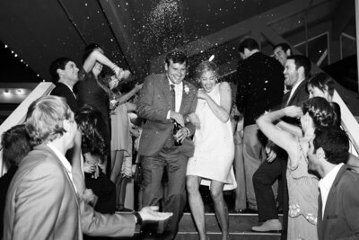 Couple exits the Jackson Hole wedding celebration: The bride and groom exit the reception, surrounded by family and friends, celebrating with confetti and laughter as they head to the next chapter of their life together.