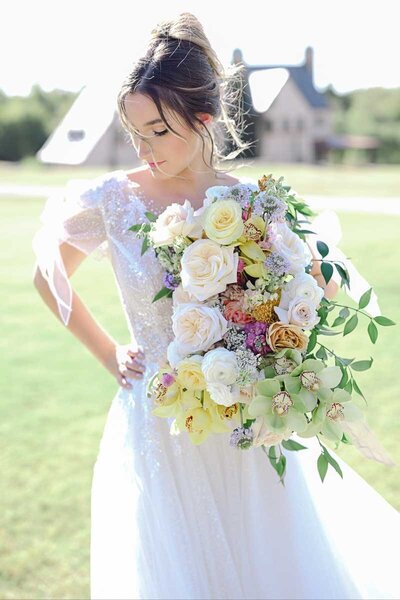 bridal portrait of woman holding her bouquet of colorful flowers