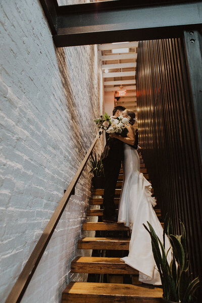 Couple embraces on stairs at Maketto Restaurant in Washington DC