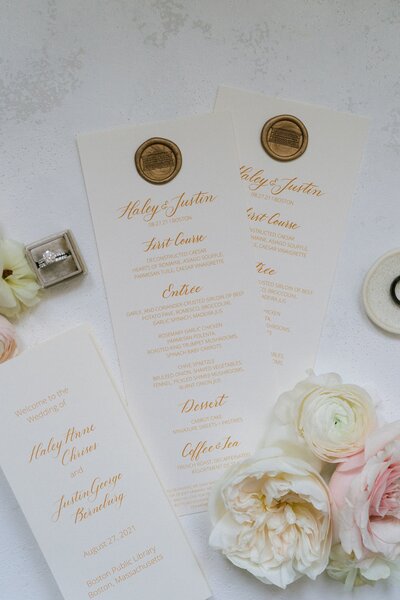 Elegant wedding day programs with wax seals and blush florals.