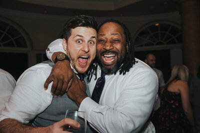 Marz, a DJ in Chicago, standing with a groom at his wedding as the best man. Both men are smiling.