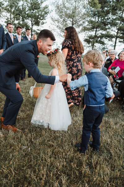 Groom fist bumps his ring bearer at wedding