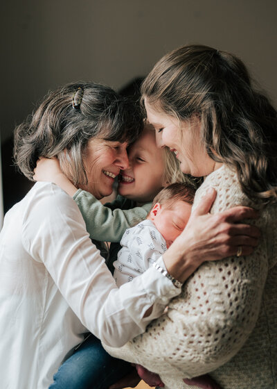three kids laughing on blanket