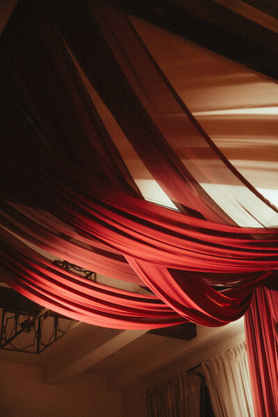 Bold red drapery details in Arizona wedding reception designed by BTO Events