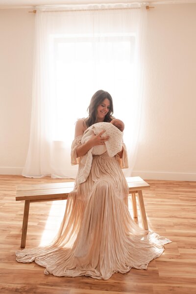 A mother holding her baby in Hope's in home studio.