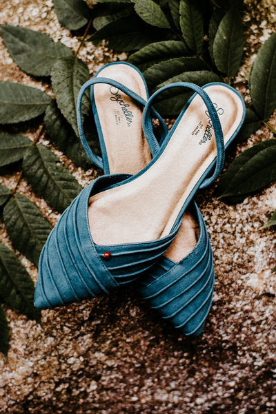 A ladybug on blue suede wedding shoes