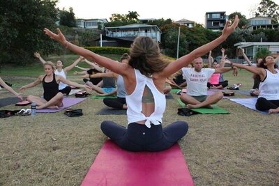 Meg O'Neill teaching yoga to a yoga class to a group of women