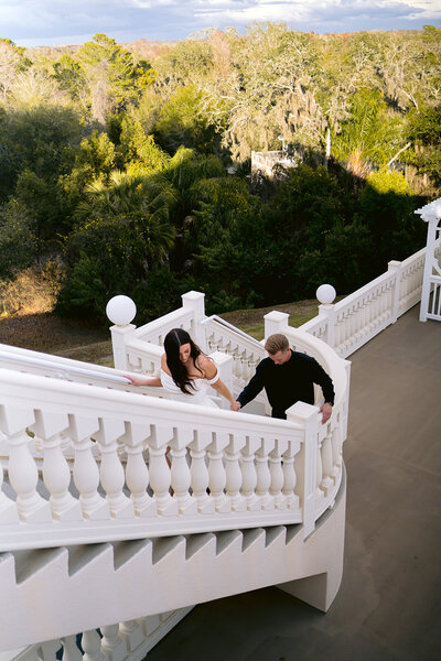 bride and groom smiling on a bridge