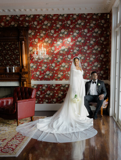 Bride putting on earrings in a sunlit bridal suite at Bella Collina, captured by a Florida luxury wedding photographer with an editorial and romantic style