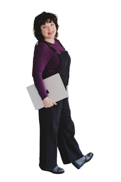 Desiree Peterson standing holding a laptop