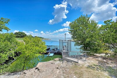 Dock access to Lake Whitney at this 3-bedroom, 2-bathroom vacation rental home with large fenced yard, firepit, and dock access with incredible views of Lake Whitney.