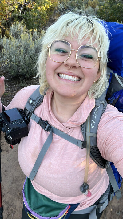 Walking through the desert in Zion National Park, camera in hand, surrounded by towering sandstone cliffs