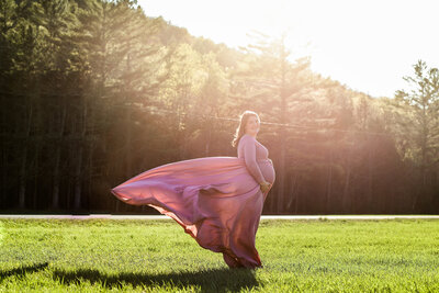 Photo of expecting Mom holding belly in color | Maine Maternity Photographer
