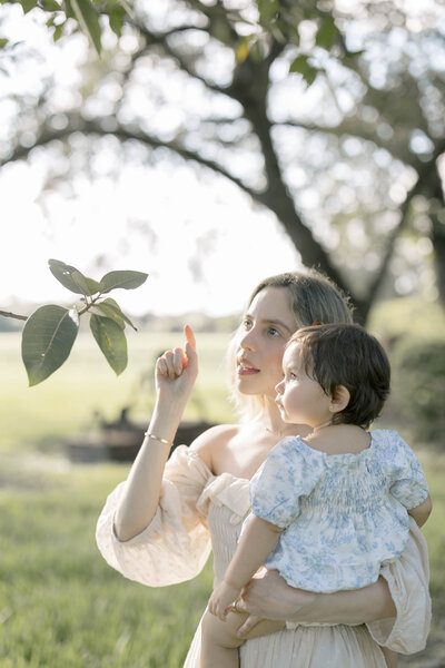 Miami family photographer Sandra Vallejo capturing mom holding daughter at the park