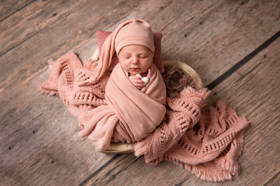 Newborn Photographer NJ baby swaddled in heart shaped bowl during photo shoot
