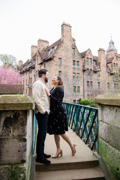 engaged couple smile at each other in Dean Village