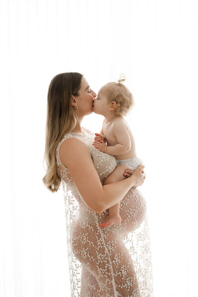 Black and white image of pregnant mother in lace dress in Sydney maternity studio 