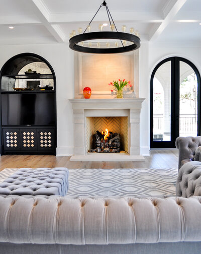 Image of white marble plaster fireplace complete with traditional mantle, curved tv cabinet to match arched doorway