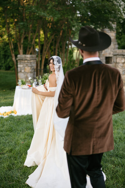 Bride with groom in a cowboy hat at warm, vibrant Nashville wedding