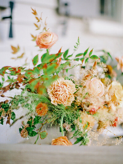 Peach, yellow and green wedding centerpiece from eco-friendly florist, Flowershop Charleston