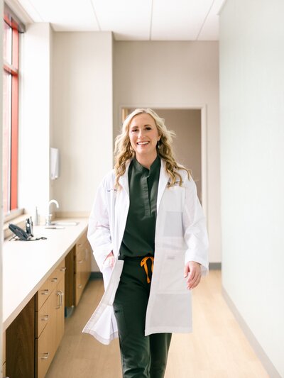 A woman sitting and posing for a headshot, looking directly at the camera