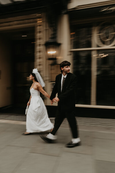 A Bride and Groom walk along the Riverwalk in Chicago.