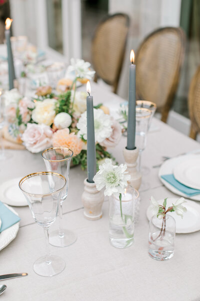 wedding table centerpieces with tall candles and flowers