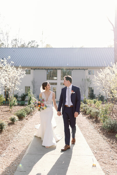 bride and groom in front of venue