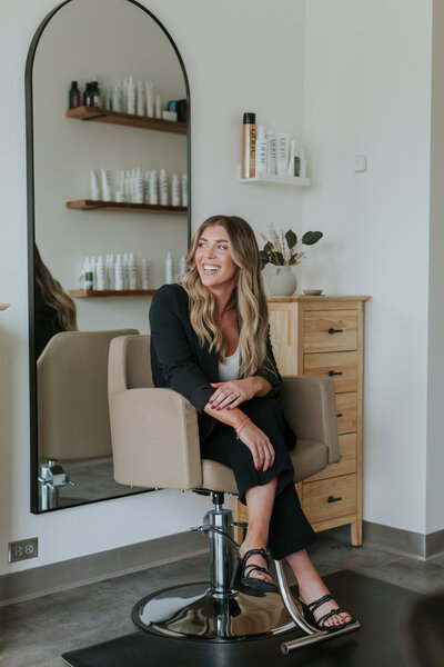 hairstylist-seated-in-salon-chair-portrait-for-brand-session-south-charlotte