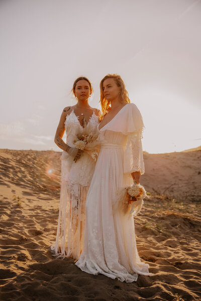 female couple pose stylishly in golden light
