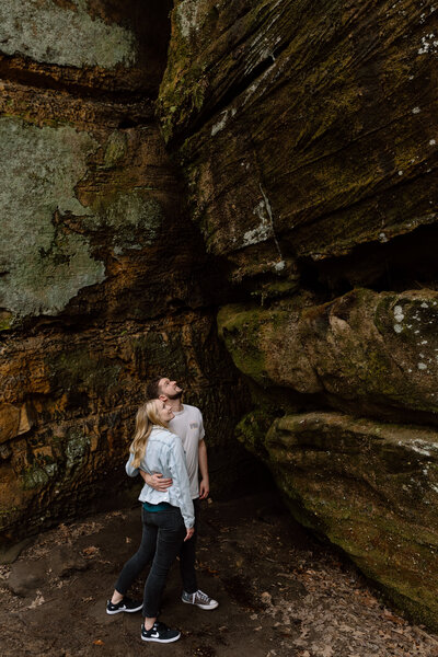 Couple looking up at rock formations in Ledges.