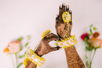 a woman's hands showing off her wedding henna designs