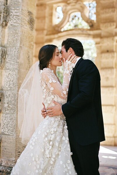 couple kissing at naples florida wedding by photographer