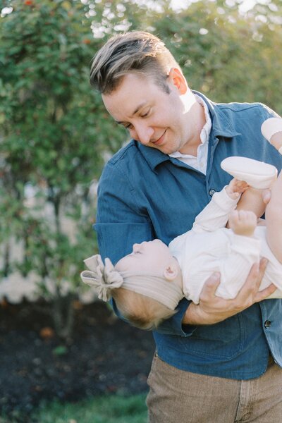 a dad playing with his baby girl