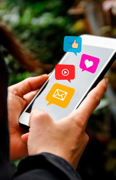 A Google Ads agency specializing in small businesses utilizes a cellphone to manage and create social media content. The image highlights the agency's expertise in digital marketing and social media strategy.