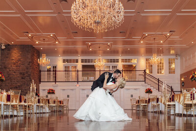The Hamilton Manor | Groom dipping bride for a kiss in the ballroom during wedding photo | Hamilton Township, New Jersey