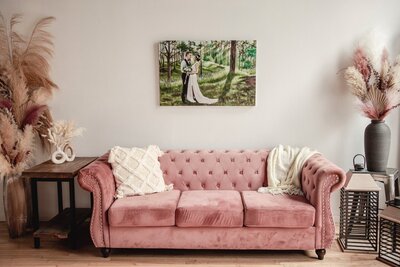 A 24 by 36 canvas hanging over a pink couch
