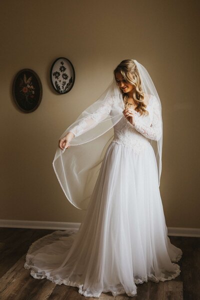 bride putting in earrings
