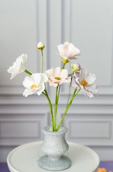 a vase of white pink and purple cosmos sugar flowers for meadow inspired wedding cakes