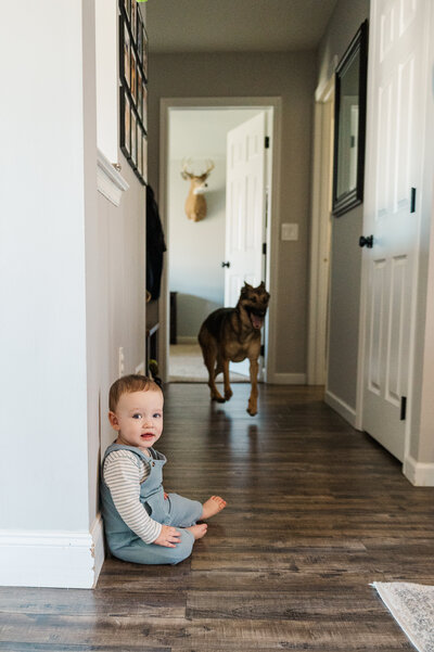 baby boy sitting on the floor in a hallway way at home session lifestyle in york pa