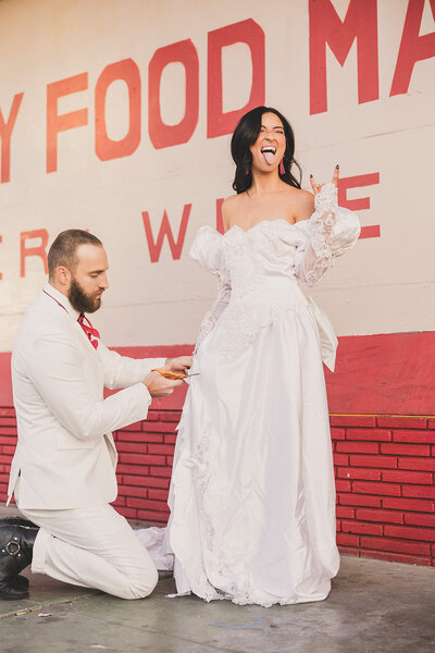 groom cutting brides dress after elopement in las vegas